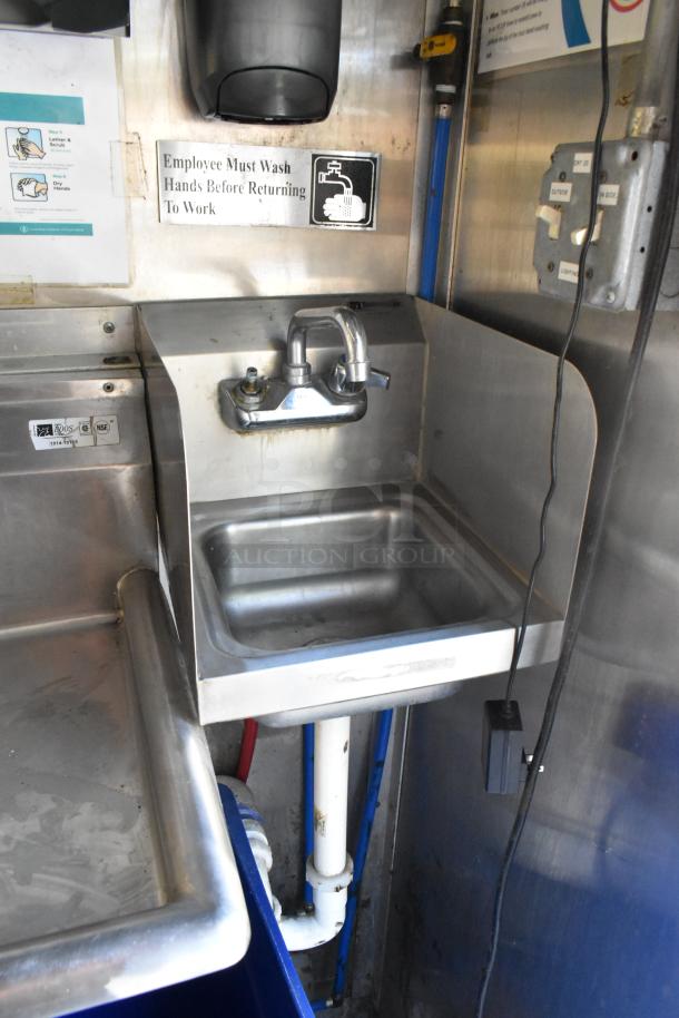 Stainless steel sink in food trailer with "Employee Must Wash Hands" sign above. Clean, well-maintained condition.