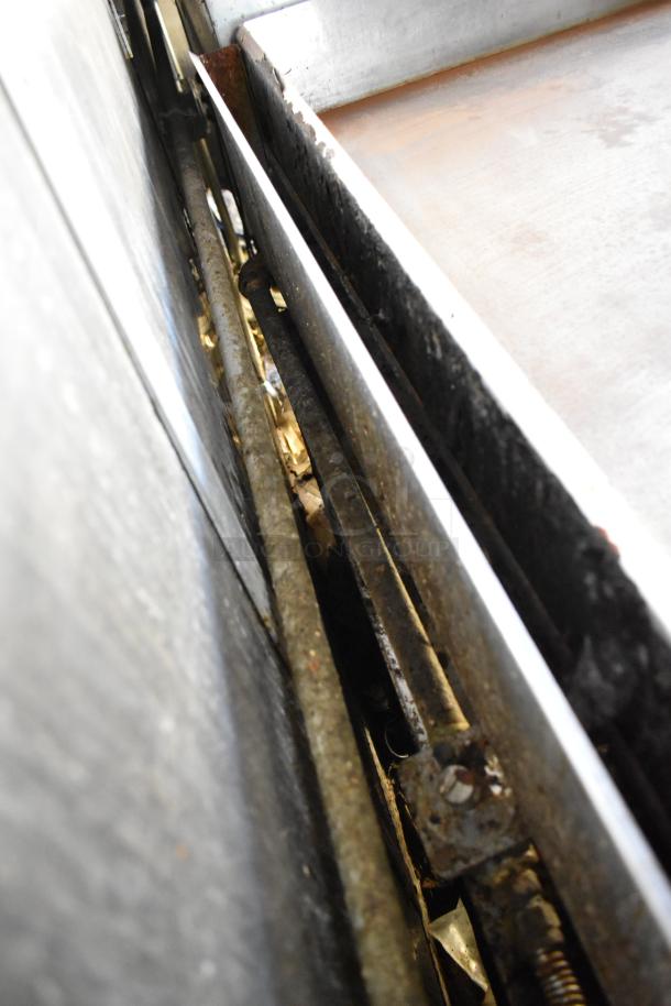 Close-up view of interior equipment in a fully outfitted food trailer from 2019, showing metal structures and components.