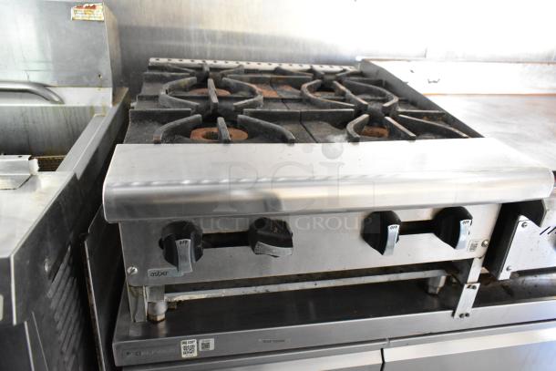 Mobile kitchen stove with four burners, stainless steel finish, Asber brand. Part of a 2019 fully outfitted food trailer.