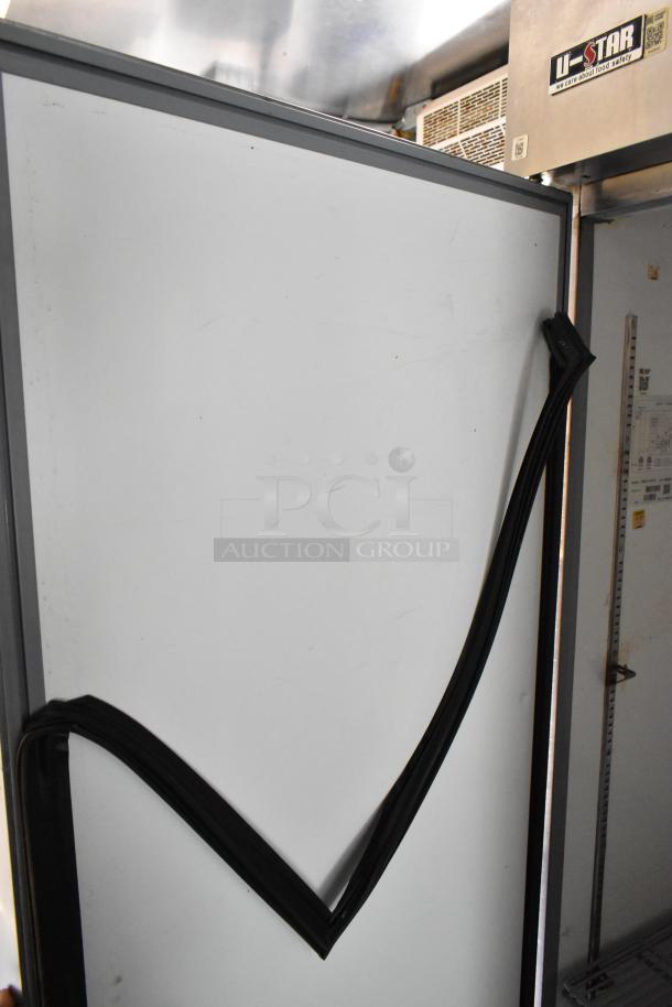 Food trailer interior showing refrigeration unit with U-Star label, indicating food safety commitment. Rubber door gasket visible.