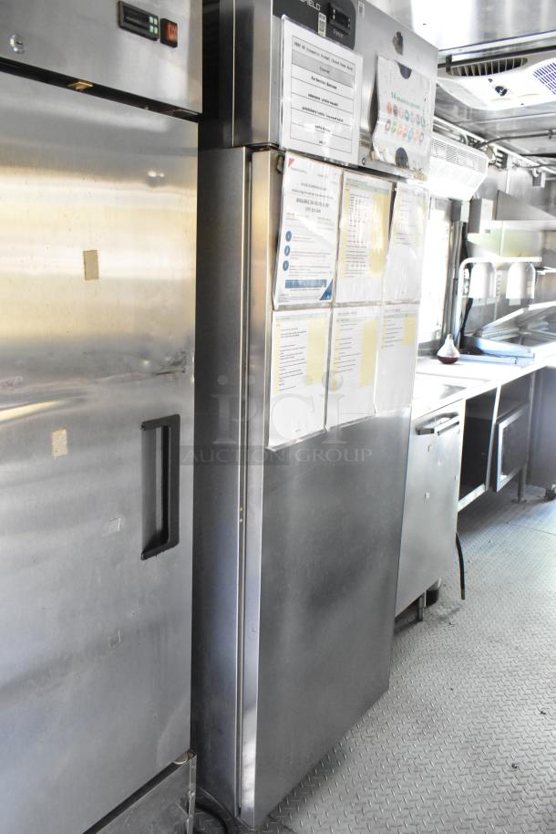 Brand new 2019 food trailer interior showing stainless steel fridge, equipment, and workspace, ready for diverse food concepts.