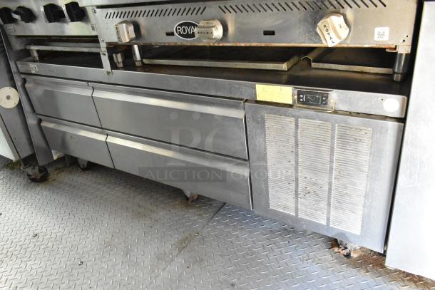 Stainless steel commercial kitchen range with Royal brand logo, featuring dual knobs, grease hood, and vented panel.