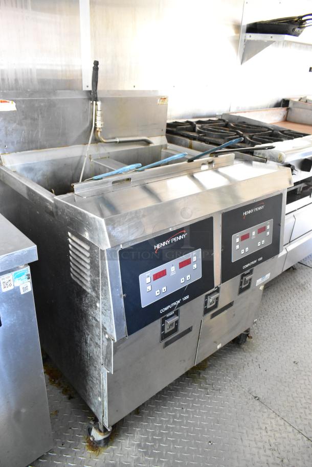 Henny Penny 2-bay fryer in brand new 2019 mobile kitchen trailer with grease hood, range, prep tables, clear title.