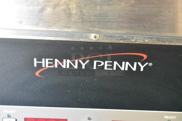Henny Penny fryer label on fully outfitted 2019 food trailer. Includes grease hood, coolers, freezers, prep tables, and more.