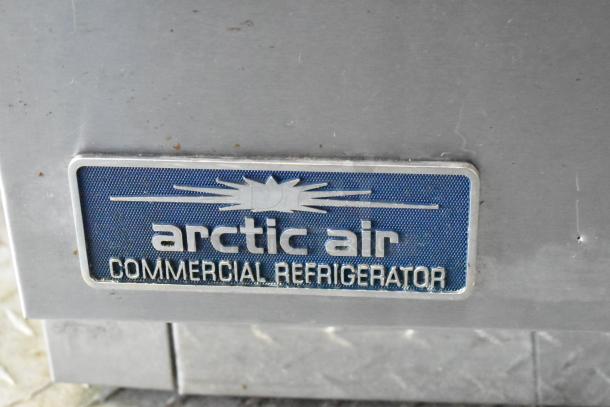 Arctic Air commercial refrigerator label on food trailer exterior.