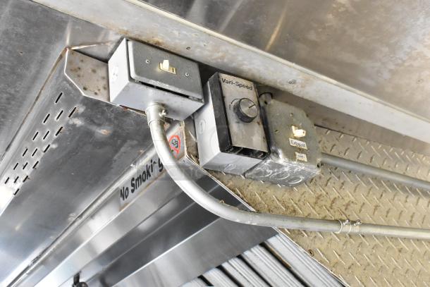 Electrical panel with "Vari-Speed" and "Exhaust" controls in a mobile kitchen food trailer. Visible "No Smoking" sign.