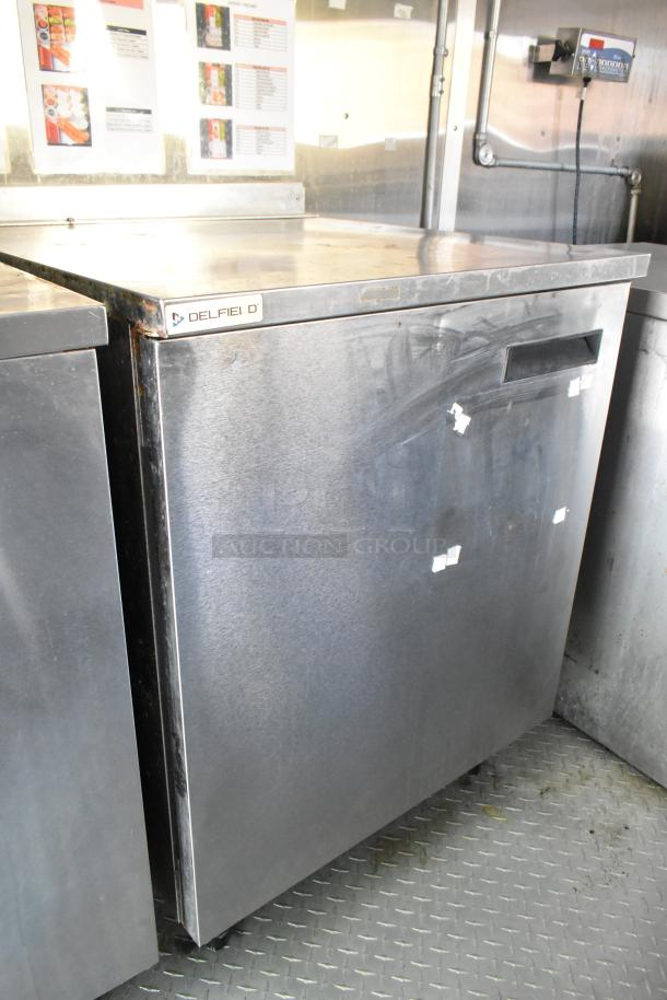 Delfield stainless steel cooler unit in food trailer, featuring clean exterior and sturdy build. Ideal for mobile kitchen use.