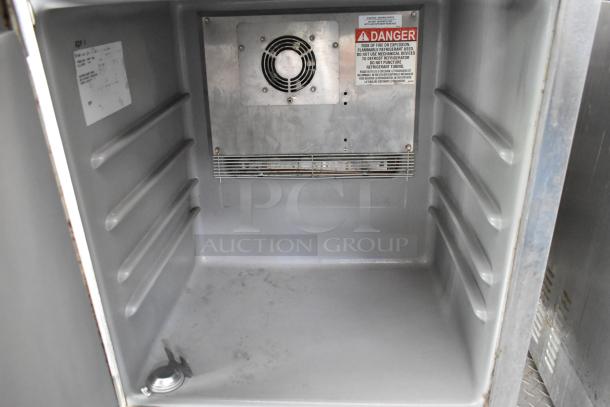 Interior view of a food trailer with a cooling unit, shelves, and a safety warning label. Clean and ready for use.