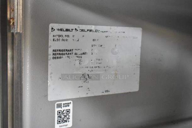Welbilt Delfield label showing model number, electrical requirements, refrigerant type, and other specifications for the food trailer equipment.