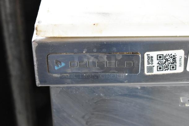 ```
Stainless steel Delfield cooler with branded logo and QR code label on front edge.
```