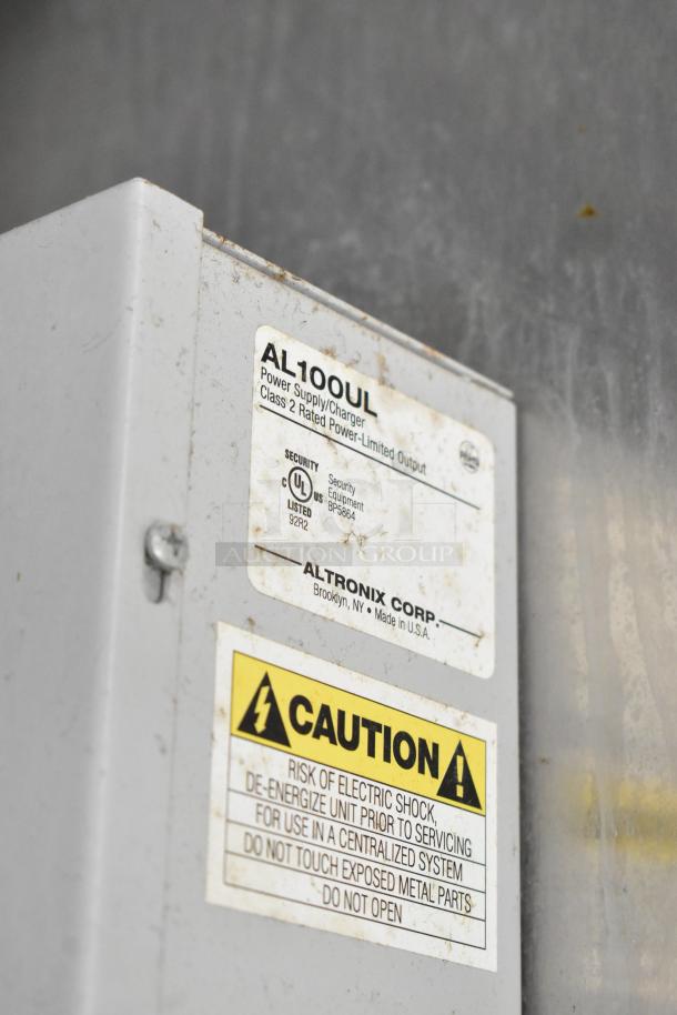 Altronix AL100UL power supply label with safety warning, indicating Class 2 rated power-limited output. Made in the USA.