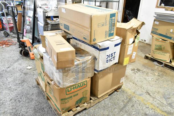Seventeen boxes on a pallet, including Cambro containers, cutlery dispenser, towel dispenser. Some boxes labeled as scratch and dent.
