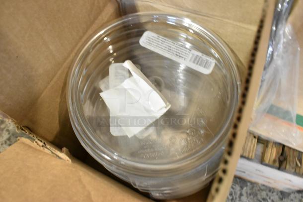 Boxes with Cambro containers, cutlery dispenser, towel dispenser. New but scratch and dent condition. Labels visible.