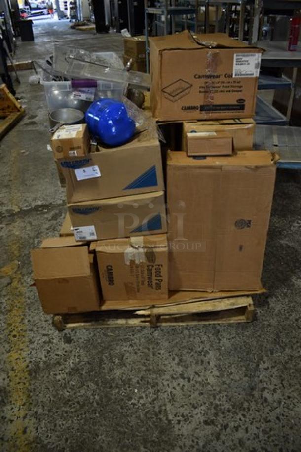 Sixteen boxes of kitchen items, including ladles, colander, and Camwear bins, labeled "Scratch and Dent," on a pallet.