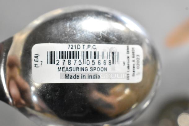 Barcoded measuring spoon labeled "721D T.P.C., Made in India." Part of a scratch and dent auction lot.