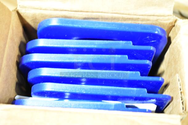 Box of brand new blue plastic items with minor scratches, including stackable trays. Ideal for kitchen use or storage.