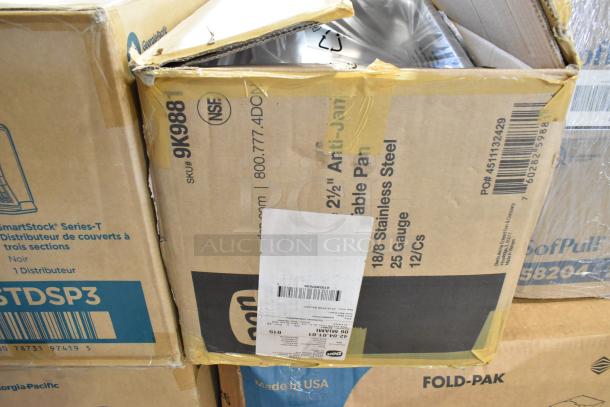 Cardboard boxes containing new kitchen items including ladles, colanders, and Camwear bins, featuring visible SKU and NSF labels. Boxes exhibit minor dents.