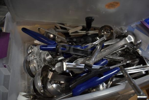 Lot of new kitchen tools in a plastic bin, including ladles and utensils, with some scratch and dent marks.