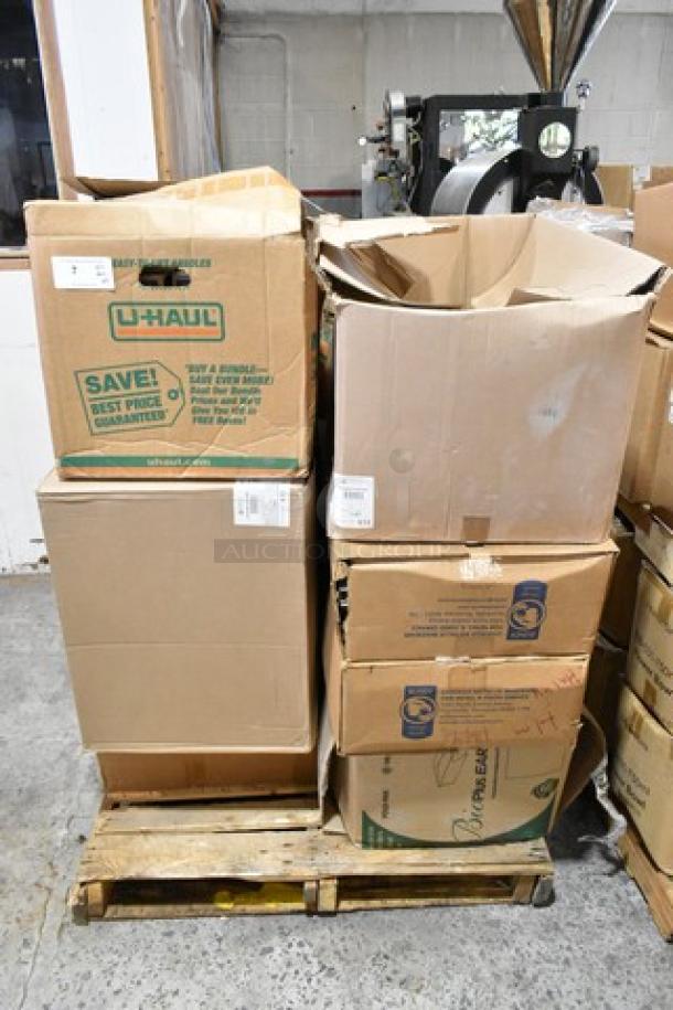 Stack of 25 cardboard boxes labeled U-Haul and others on a pallet, containing Carlisle food pan smart lids and to-go containers.