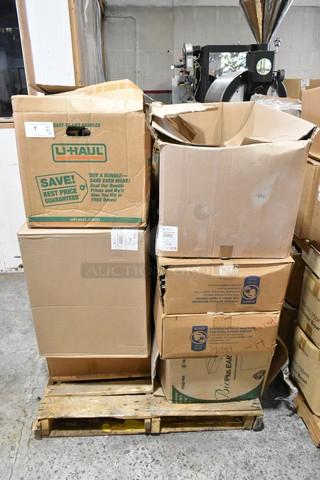 Stack of 25 cardboard boxes labeled U-Haul and others on a pallet, containing Carlisle food pan smart lids and to-go containers.