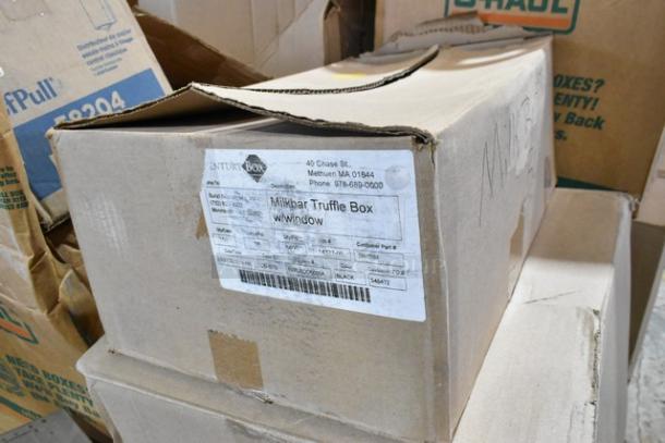 Cardboard box labeled "Milkbar Truffle Box" with visible address and contact details. Box condition: slightly damaged.