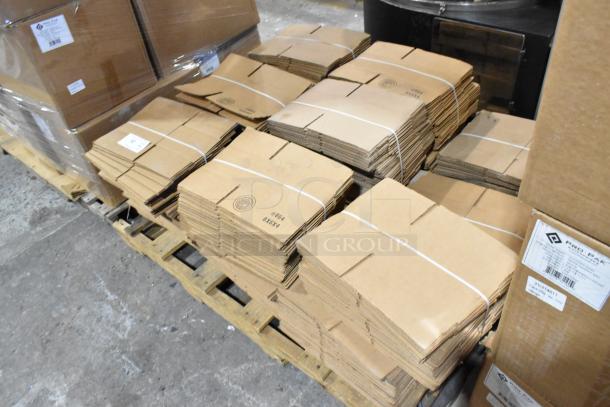Bundles of brand new cardboard boxes, size 8x6x4, on a pallet. Includes 16 bundles with labels indicating minor damage.