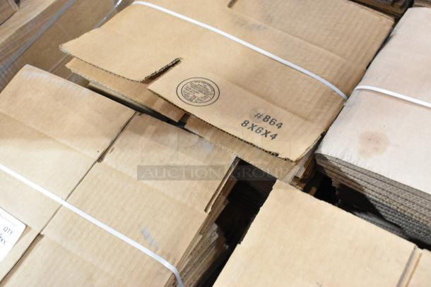 16 bundles of new scratch and dent cardboard boxes, including 8x6x4 size, securely strapped. Marking: "#864 8X6X4".