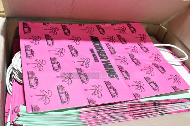 Box of brand new ProPak paper handle bags featuring "Another Wing" design. Pink with black graphics, unopened condition.