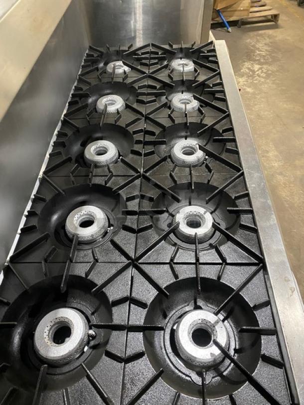 Vulcan commercial stainless steel 10-burner range; includes double ovens, backsplash, overhead salamander shelf, on casters.