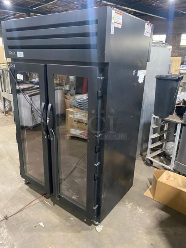 True Commercial Black Double Glass Swing Door Reach-In Refrigerator, Model STG2RPTVLD2G2SHC. Features poly-coated wire racks, serial number 10547031, 115V 1 Phase, includes casters.