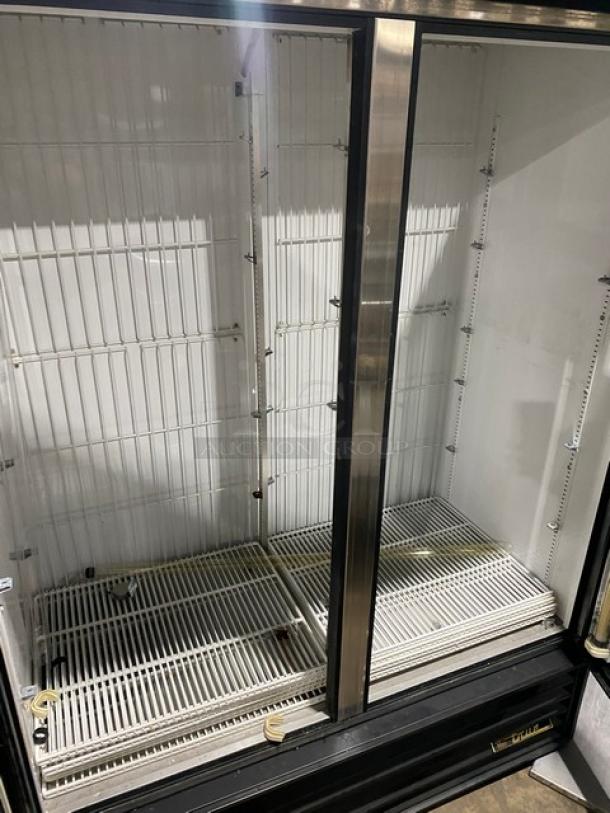 True GDM-49F commercial freezer with double glass swing doors, poly-coated wire racks, good condition, 115/208-230V.