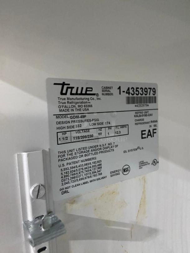 True GDM-49F commercial freezer label with model, voltage, phase details, and NSF certification. Serial number: 1-4353979.