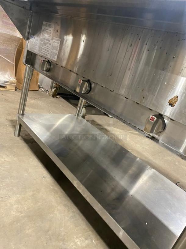Diamond GST4830 stainless steel 3-well steamtable with natural gas control knobs, single undershelf, tray slide, and legs.