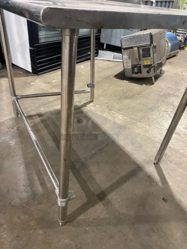 Commercial stainless steel open base worktop table on legs, sleek design, durable material, ideal for kitchen use, sturdy condition.