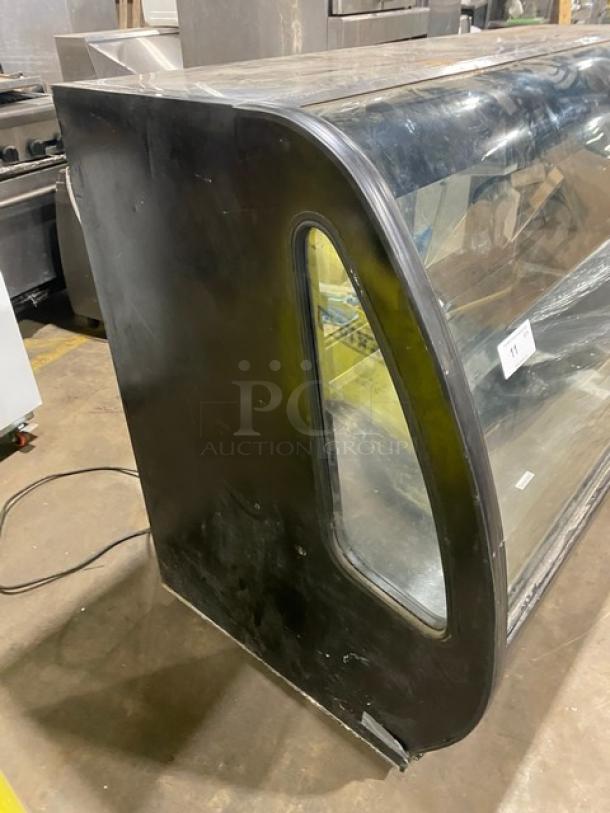 Tor-Rey black curved glass refrigerated bakery display, model TEM200NG. Features rear double glass sliding door. Slight wear.