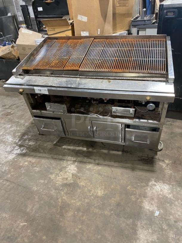 Commercial stainless steel Chitwood smoker/char broiler grill with pan slide, enclosed storage base, and casters.