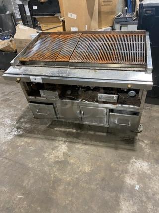 Commercial stainless steel Chitwood smoker/char broiler grill with pan slide, enclosed storage base, and casters.