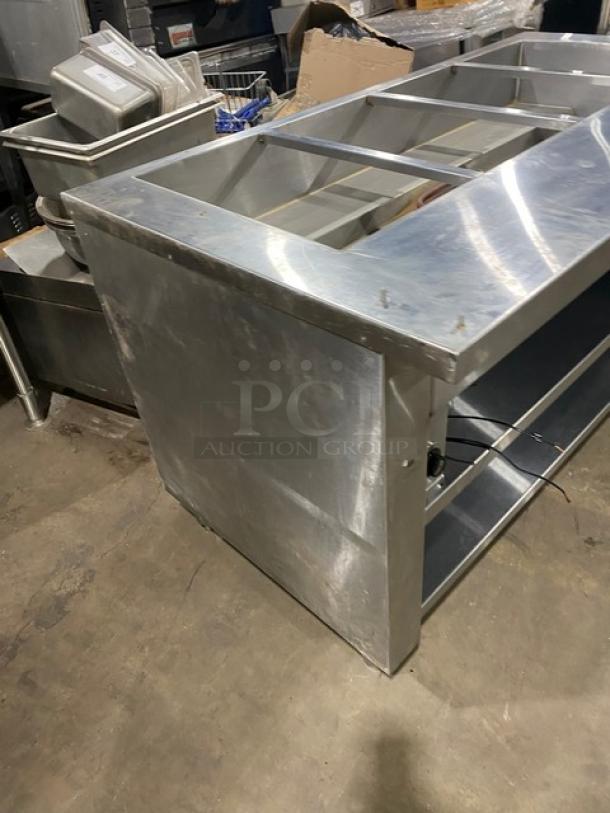 Cecilware stainless steel 4-well electric steamtable with tray slide, enclosed double shelf base, on legs.