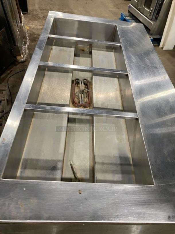 Cecilware stainless steel electric 4-well hot food steamtable, with tray slide and enclosed double shelf base, on legs.