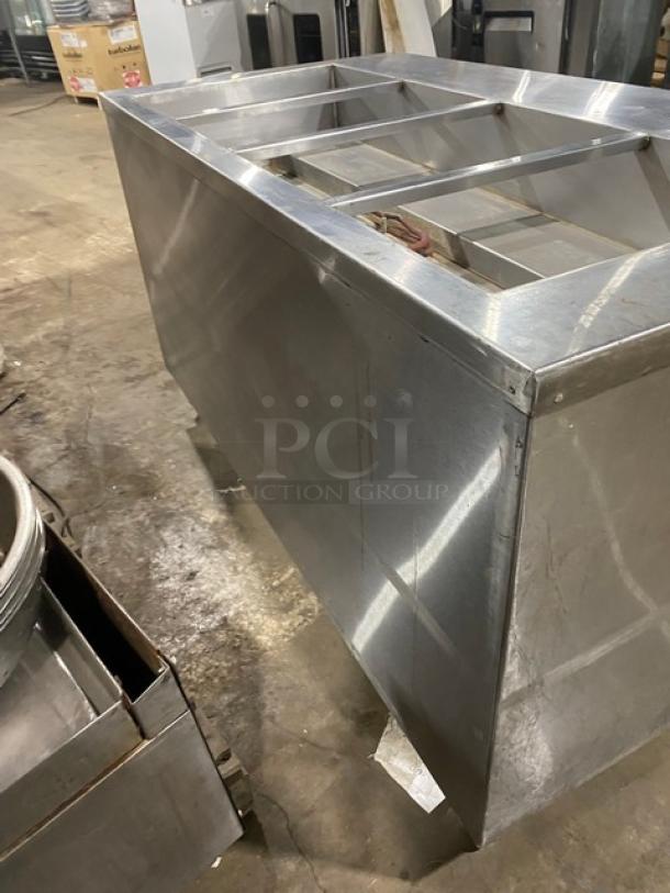 Cecilware stainless steel 4-well steamtable with tray slide, enclosed double shelf base, on legs; commercial condition.