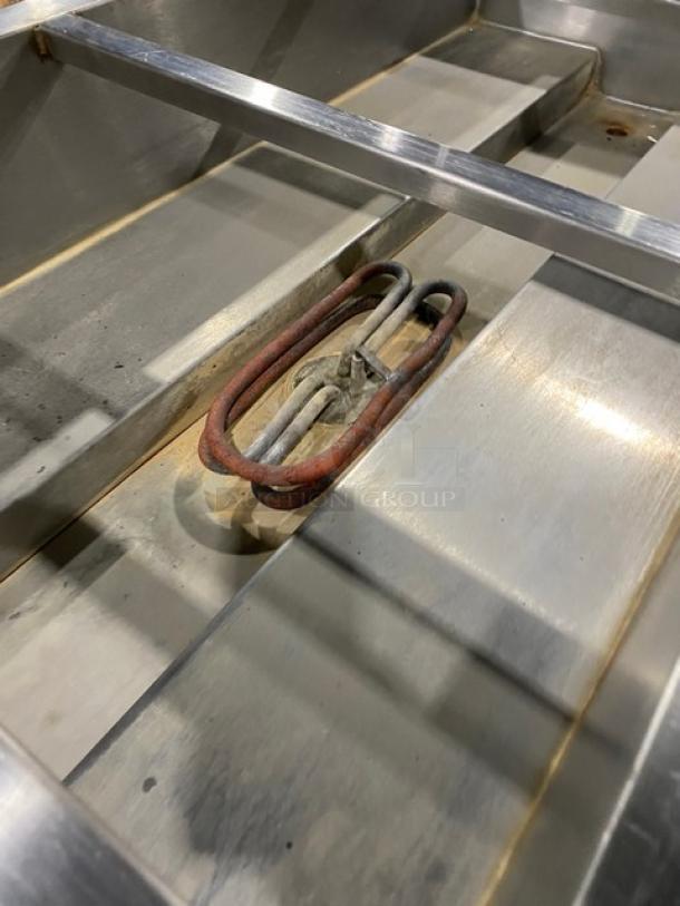 Cecilware commercial stainless steel electric 4-well steam table with tray slide, enclosed double shelf base; visible heating element.