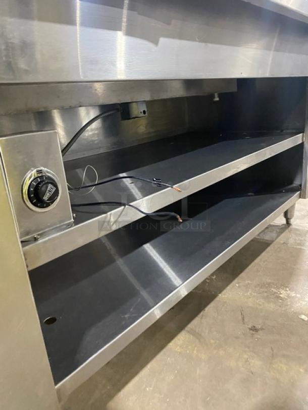 Cecilware stainless steel 4-well steam table with tray slide, electric, enclosed double shelf base, and control knob on legs.