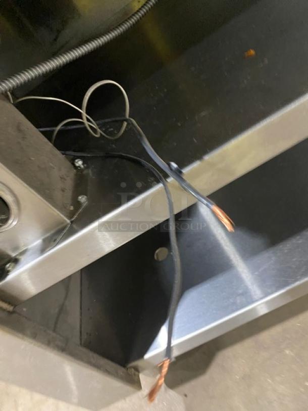 Cecilware stainless steel 4-well steam table with tray slide, enclosed double shelf base, and legs; shows wiring for electrical setup.