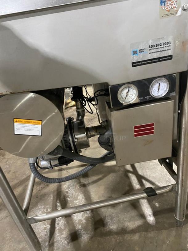 Jackson TempStar Series commercial stainless steel door-type dishwasher on legs, electric powered. Features control gauges.