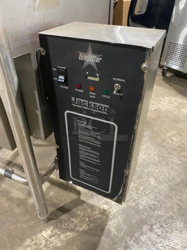 Jackson TempStar Series commercial dishwasher, stainless steel, electric-powered, door-type, on legs. Control panel visible.