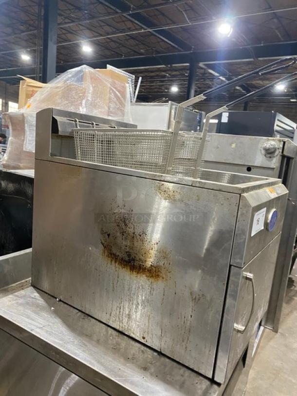 Globe GF30G stainless steel countertop deep fat fryer with backsplash. Includes fry baskets and basket hanger. Used condition.