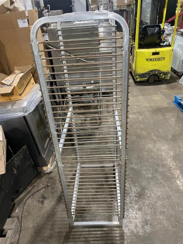 Commercial heavy-duty pan holding rack, vertical design with multiple slots, metal construction, used condition.