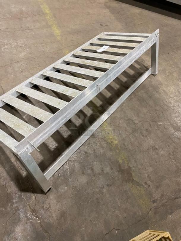 Commercial aluminum T-bar wall shelf, sturdy and durable, in good condition. Perfect for storage and organization.