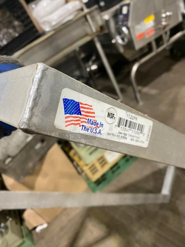Commercial aluminum T-bar wall shelf with NSF certification, made in the USA, showing a label with product details.