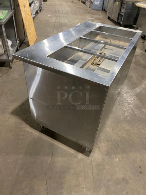 Cecilware stainless steel 4-well hot food steamtable with enclosed double shelf base, electric powered, on legs.